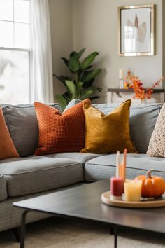 Grey couch with autumn accents Burnt Orange Pillows Living Rooms, Orange Pillows Living Room, Burnt Orange And Grey Living Room, Grey And Burnt Orange Living Room, Grey Couch Blue Walls, Orange And Grey Living Room Decor, Grey Couch Pillow Ideas, Grey And Orange Living Room, Fall Living Room Decor Ideas