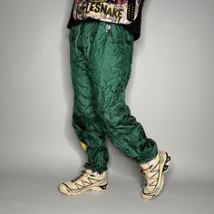 "Vintage Pro Player Track Pants Packers Green Yellow Nylon Joggers Elastic Cuffs has Ankle Zippers Lined 90s Skate / Streetwear Great Condition: 9/10 Men's Size: Large My Hands in Pockets = It has Pockets No Hands in Pockets = Does Not Have Pockets Drawstring Will be Visible in Forward Pic, if not Visible it Does Not Have a Drawstring About me: I am 6' 0\" for reference I generally wear a Large (32\" inseam) I Model XS to 2XL sweatpants, I find that you can often size up or down with 95% of sweatpants and they fit the same" Green Nylon Sporty Parachute Pants, Green Parachute Pants With Elastic Waistband For Streetwear, Green Stretch Parachute Pants For Outdoor, Green Nylon Parachute Pants For Streetwear, Casual Green Nylon Parachute Pants, Green Parachute Pants For Streetwear, Retro Stretch Pants For Streetwear, Green Nylon Outdoor Bottoms, Green Nylon Parachute Pants For Summer