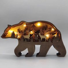 a wooden bear with christmas lights on its back