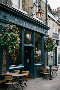 the outside of a restaurant with tables and chairs