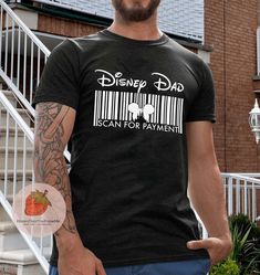 a man standing in front of a building wearing a barcode t - shirt that says disney