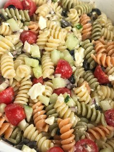 a bowl filled with pasta salad and dressing