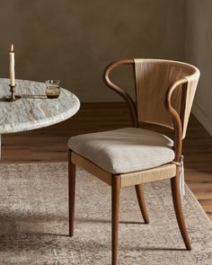 a dining room table and chair with a candle on it