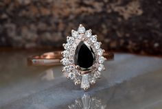 a black diamond ring sitting on top of a table