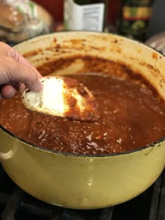 a person scooping some food out of a pot with the words grandma frank's spaghetti sauce on it