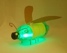 a green light up toy bee sitting on top of a table