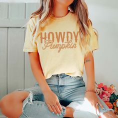 Hey there, autumn lover! Ready to embrace the cozy vibes of the season? Our Howdy Pumpkin Comfort Color Graphic Tee is perfect for showcasing your love for fall with a playful twist. Whether you're heading to a pumpkin patch, enjoying a bonfire, or sipping on your favorite spiced latte, this tee combines comfort with seasonal charm. Crafted from ultra-soft, high-quality cotton, our Howdy Pumpkin Comfort Color Graphic Tee ensures comfort and durability throughout the season. Its relaxed fit and premium fabric keep you cozy and stylish as you enjoy all your favorite fall activities. Featuring a cheerful "Howdy Pumpkin" design, this tee adds a fun and festive element to your autumn wardrobe. It pairs effortlessly with jeans, leggings, or your favorite flannel, making it a versatile piece for Trendy Soft-washed Tops For Fall, Cute Orange Fall Tops, Cute Orange Top For Fall, Cute Orange Tops For Fall, Trendy Soft-washed Fall Tops, Cute Orange Fall Top, Yellow Graphic Tee For Fall, Oversized Fall Graphic T-shirt, Fall Graphic Tee Soft-washed