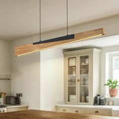 a kitchen with a wooden counter top next to a window