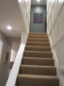 there is a set of stairs leading up to the second floor with carpeted steps