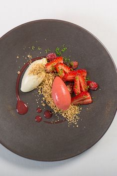 a plate with strawberries, an egg and other food items on top of it