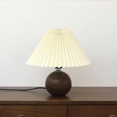 a lamp sitting on top of a wooden dresser