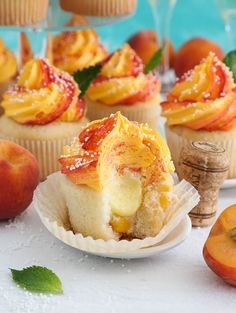 cupcakes with peaches and powdered sugar on them