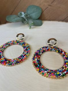 Hand beaded hoops with assorted glass beads. Earring setting is high quality gold plated brass.  Earring lengths are 4.5 inches Earring widths are 2.5 inches Beaded Hoops, Hand Beading, Confetti, Jewelry Earrings Dangle, Etsy Earrings, Glass Beads, Dangle Drop Earrings, Dangle Earrings, Hoop Earrings