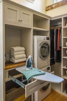 an ironing board and dryer in a closet with clothes on the shelf next to it