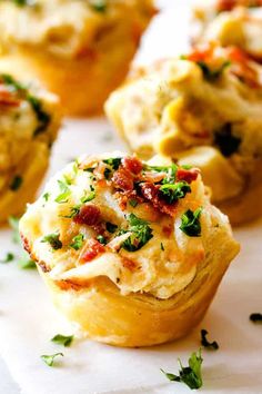 several small muffins with bacon and cheese on them