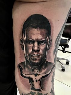 a man's leg with a tattoo on it that has a portrait of him