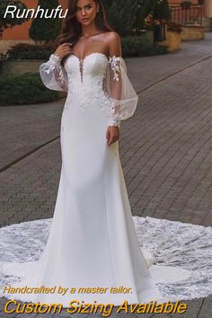 a woman in a white wedding dress posing for the camera with her hands on her hips