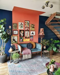 a living room filled with furniture and lots of pictures on the wall next to a stair case