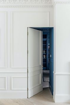 an open door leading into a room with white walls