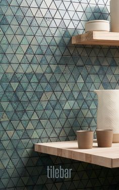 The Bushwick Aquamarine Green 2" Triangle Glossy Lava Stone Mosaic Tile is a blend of delicately decorative and toughly industrial, with bold geometric triangles with a glossy green glaze softened by their romantic, small size. This contrast makes this tile suitable for a wide range of applications. Bushwick is attached to mesh sheeting for ease of installation, and the tile's porous structure is waterproof, resisting fading, chemicals, and slips. Pool Waterline, Waterline Tile, Tile For Kitchen Backsplash, Tile For Kitchen, Outdoor Pavers, Green Triangle, Tiles For Bathroom, Geometric Triangles, Stone Mosaic Tile