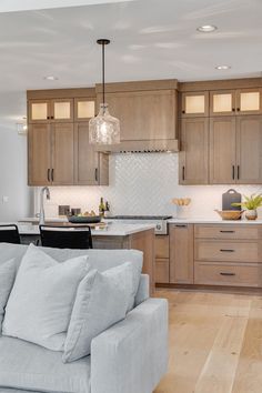 a living room filled with furniture next to a kitchen