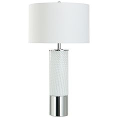 a lamp with a white shade on top of it and a silver metal frame around the base