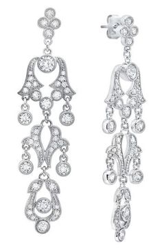 Andrew Prince's regal design DNA is infused into every part of these luxe drop earrings featuring milgrain detailing and brilliant-cut crystals. 2 5/8" drop; 1/2" width Hypoallergenic Rhodium plate/crystal Imported Classic Drop Chandelier Earrings With Diamond Accents, Classic Diamond Chandelier Earrings With Diamond Accents, Classic Drop Chandelier Earrings With Elegant Design, Classic Diamond Chandelier Drop Earrings, Classic Pierced Chandelier Earrings For Formal Occasions, Classic Formal Chandelier Earrings With Intricate Design, Classic Long Drop Diamond Earrings With Accents, Classic Silver Chandelier Earrings With Diamond Accents, Classic Formal Chandelier Earrings