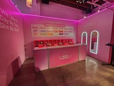 a pink room with lights and signs on the walls