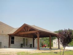 a house with a covered patio in the front yard