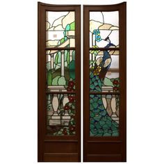 two stained glass doors with peacocks on them