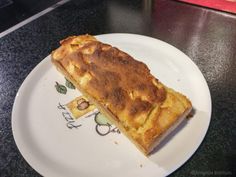 a piece of food sitting on top of a white plate