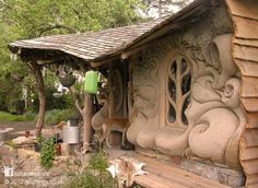 a stone house with decorative carvings on the side