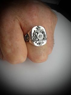 Royal Green Jackets Oxidized Sterling Silver Ring Face of Ring is 22mm high by 18mm wide. Our Bespoke Military Signet ring is a true modern classic, handcrafted in our Studio workshops by our skilled Silversmith Artisans in solid sterling silver with oxidized emblem on a highly polished background. This unique Military Signet ring has a wonderful comfort fit and is perfect for men. You also have the option of having it engraved and personalized with initials,surname and military number on the in Classic Formal Skull Ring With Polished Finish, Classic Polished Skull Ring For Anniversary, Classic Skull Ring For Anniversary, Classic Skull Ring As Gift With Polished Finish, Classic Skull Ring Gift, Classic Sterling Silver Skull Ring With Polished Finish, Classic Polished Skull Ring Collectible, Classic Handmade Rings, Army Rings