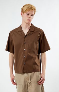 Unwind in style with PacSun's Solid Oversized Camp Shirt. Boasting a laid-back vibe with its collared neckline, short sleeves, and relaxed fit, this shirt is perfect for casual outings. Complete with a left chest pocket for added convenience, it's a versatile wardrobe staple for easy, breezy days.


	Collared neckline
	Short sleeves
	Oversized fit
	Button closures
	Left chest pocket
	69% cotton, 26% nylon, 5% spandex
	Machine washable
	Model is wearing size medium
	Model Measurements: 6’3”  Height, 28” Waist, 33.5” Hips Summer Collared Short Sleeve Shirt With Pockets, Casual Solid Camp Shirt With Johnny Collar, Casual Brown Top With Johnny Collar, Summer Shirt With Short Sleeves And Pockets, Casual Brown Johnny Collar Top, Summer Shirt With Pockets And Collared Neckline, Summer Short Sleeve Shirt With Lapel Collar And Pockets, Summer Short Sleeve Shirt With Pockets And Lapel Collar, Brown Relaxed Fit Button-up Camp Shirt