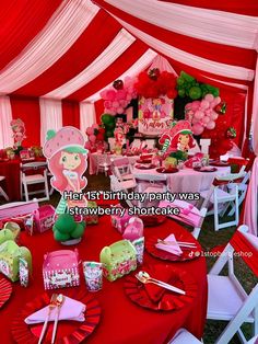 an image of a birthday party with pink and green decorations on the table in front of a red tent