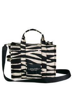 Easy top handles and an optional, adjustable strap provide convenient carrying options for this zebra-striped canvas tote that folds flat for storage or travel. Top zip closure Top carry handles; removable, adjustable crossbody strap Interior zip pocket Lined Textile Imported Designer Handbags Everyday Use Zebra Print Tote Bag, Everyday Zebra Print Tote Bag, Travel Zebra Print Rectangular Bag, Travel Rectangular Zebra Print Bag, Rectangular Zebra Print Travel Bag, Everyday White Zebra Print Bag, Marc Jacobs The Tote Bag, The Medium, The Tote Bag