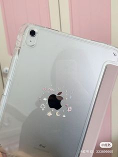 an apple ipad case is shown in front of a pink door with flowers and butterflies on it