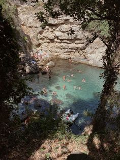 people are swimming in the clear blue water