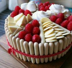 a cake with white frosting and raspberries on top