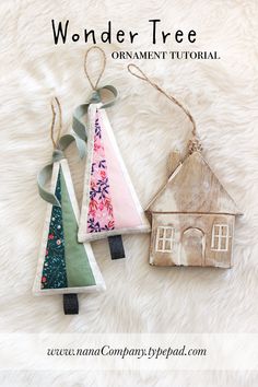 two ornaments made out of wood are sitting on a white furnishing with the words wonder tree ornament