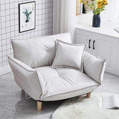 a living room with white furniture and flowers