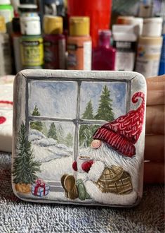 a hand painted glass block with a santa clause looking out the window