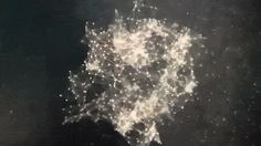 an aerial view of the city at night from space, with lights shining on it