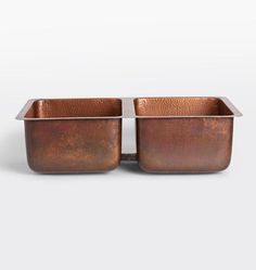 two square copper pots with handles on each side, one is empty and the other has no lid