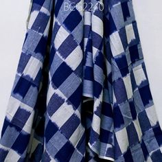 a blue and white checkered shirt hanging on a wall