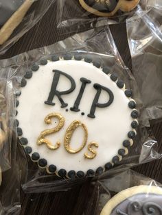 a cake with the number 20 on it and decorated cookies in the shape of cookies