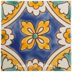 an artistic tile design with yellow and blue flowers