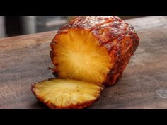 a piece of pineapple sitting on top of a wooden cutting board