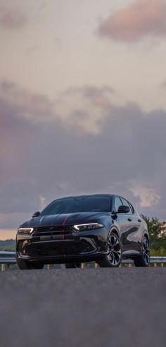 a black car parked on the side of a road