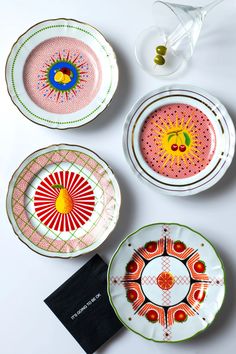 three plates with designs on them sitting next to each other